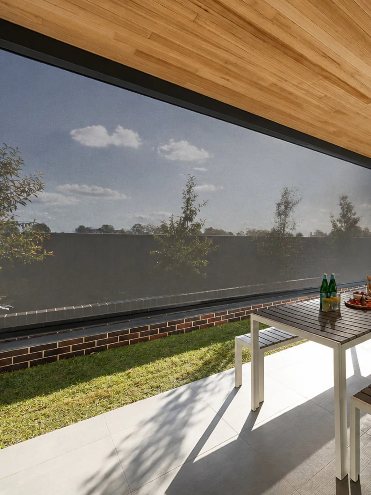A heavy-duty zip-track outdoor screen enclosing a covered patio